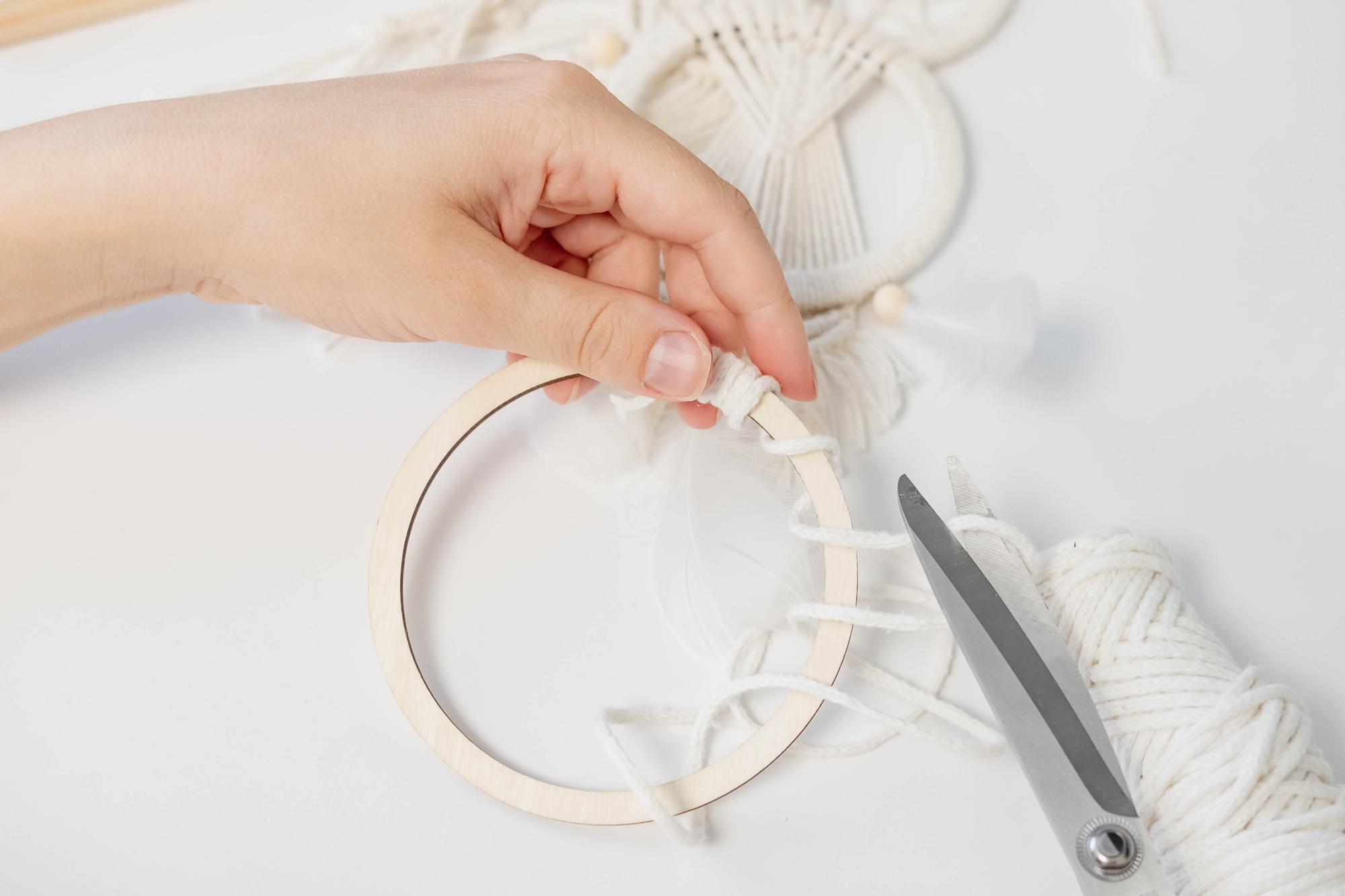 artist at embroidery hoop in studio