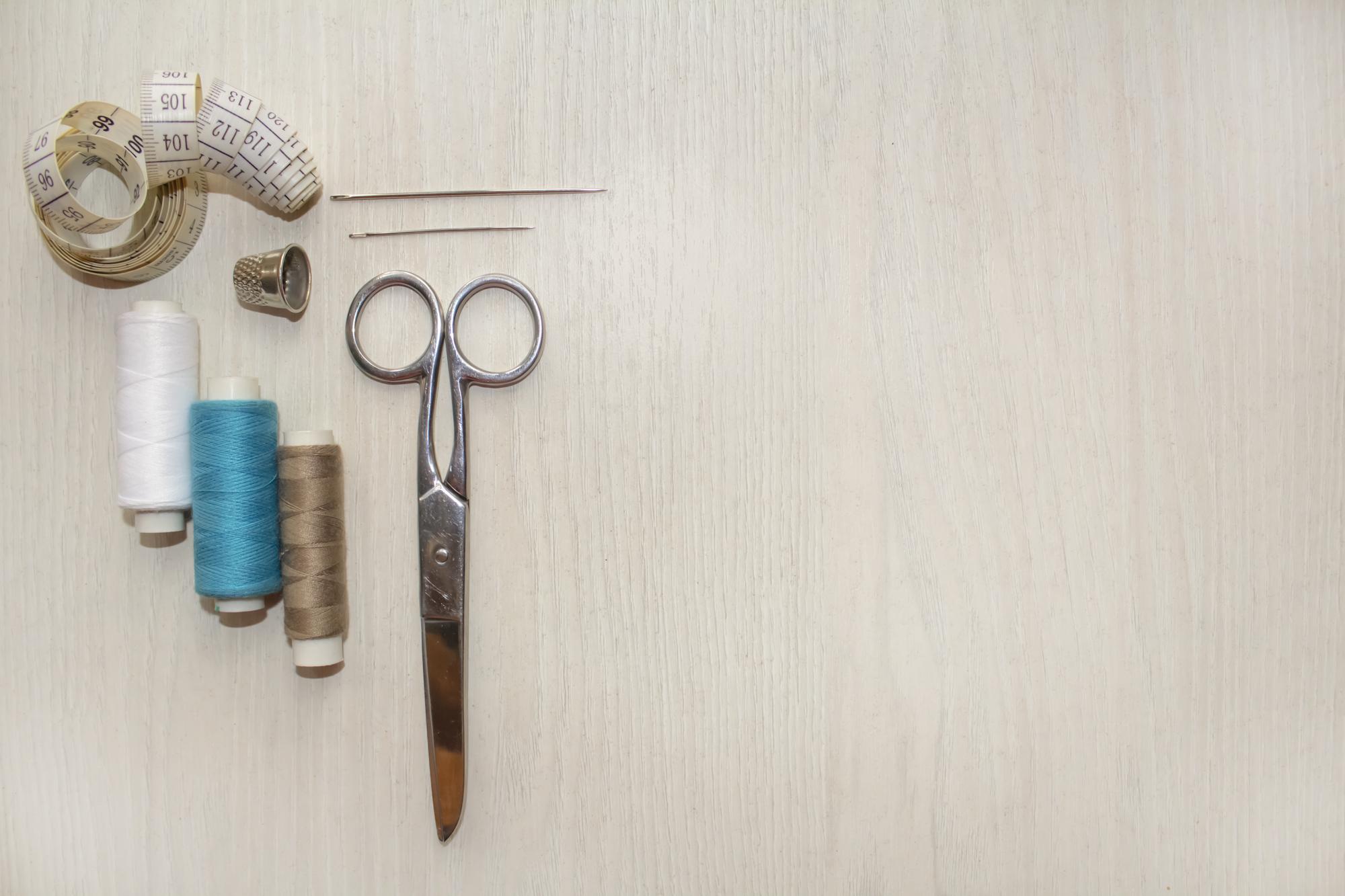 flatlay of embroidery threads and tools